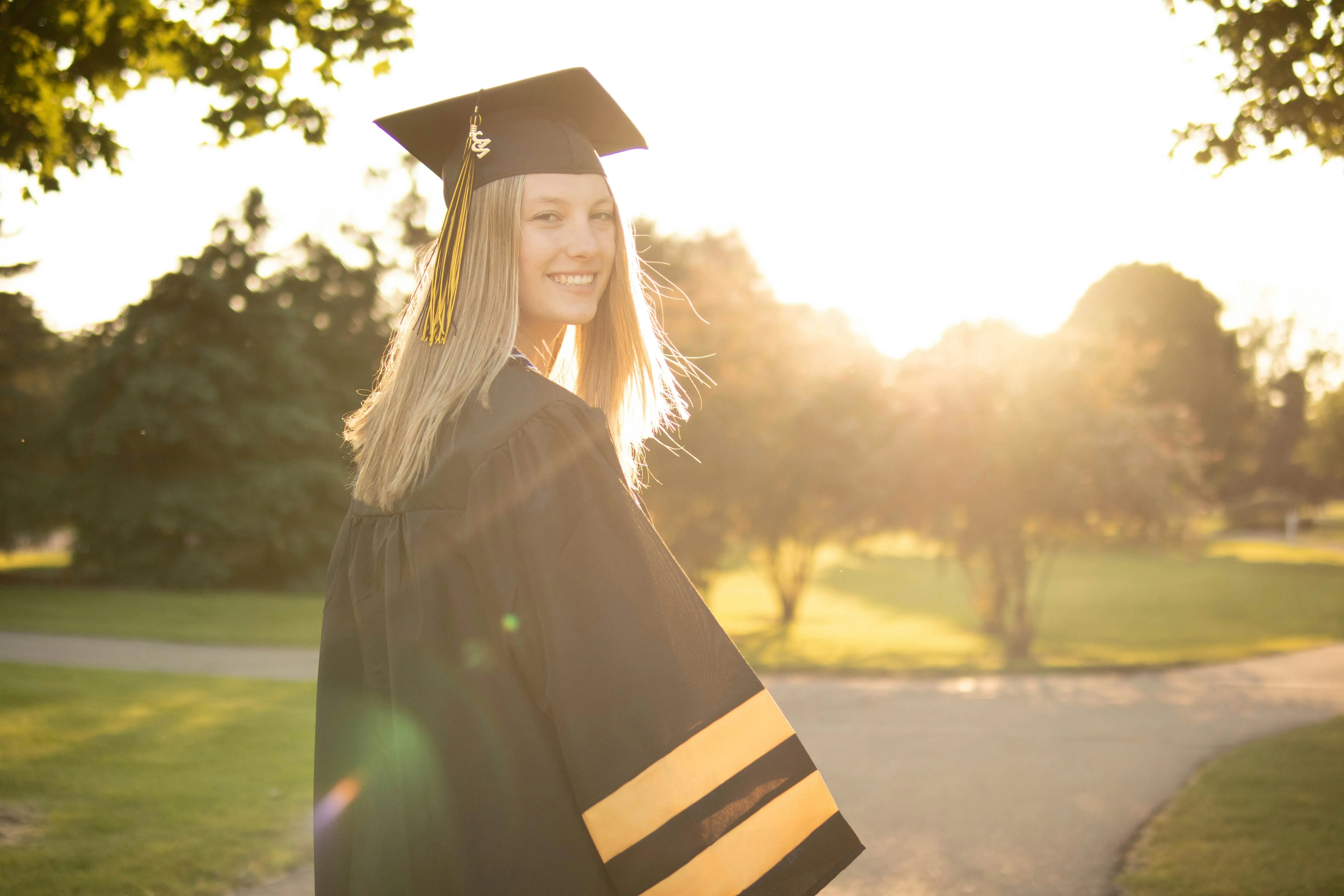 A graduate at golden hour on graduation day